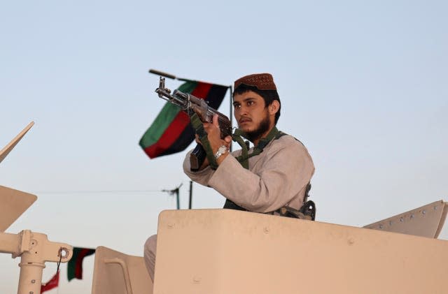 A Taliban fighter stands guard at a checkpoint in Kabul, Afghanistan 