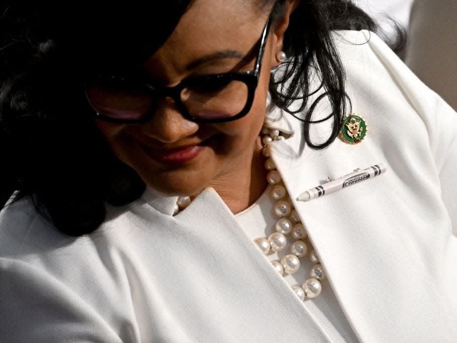 A lawmaker wears a pin of a white Crayola crayon during the State of the Union address in the House Chamber of the US Capitol in Washington, DC, on February 7, 2023.