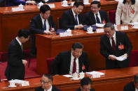 Chinese President Xi Jinping, center, leaves as Chinese Premier Li Qiang, right, looks after the opening session of the National People's Congress (NPC) at the Great Hall of the People in Beijing, China, Tuesday, March 5, 2024. (AP Photo/Andy Wong)