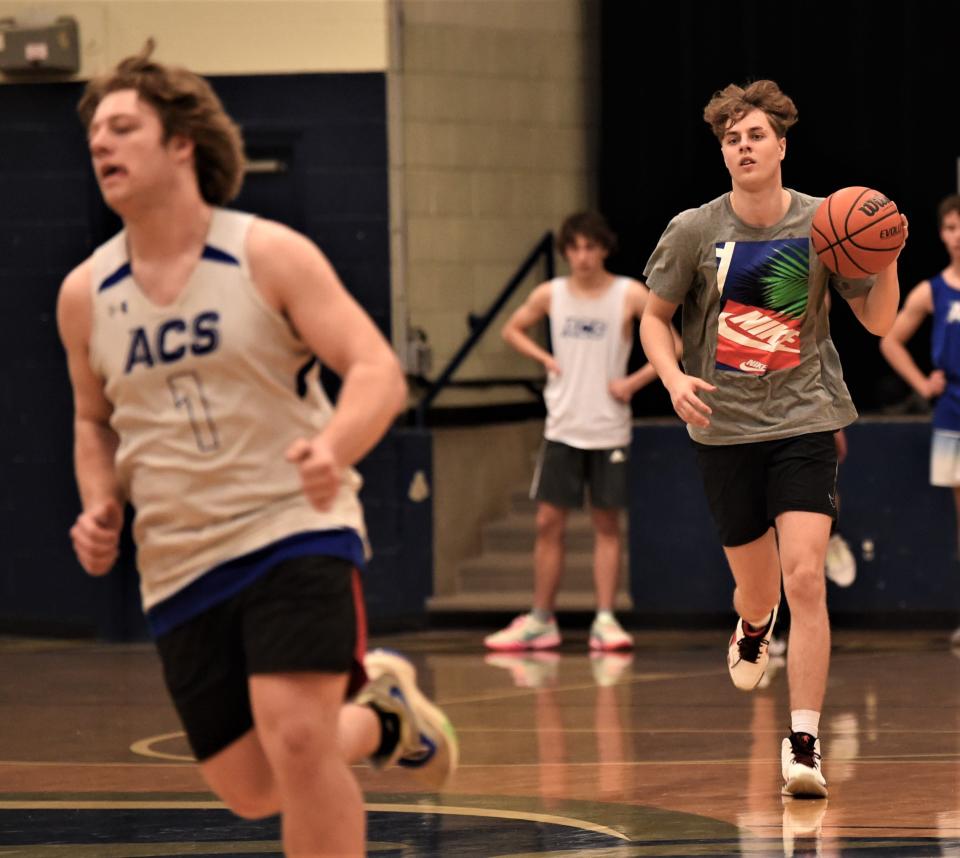 Abilene Christian High senior KJ Kriviss, right, brings the ball up court during practice Monday at the ACHS gym.