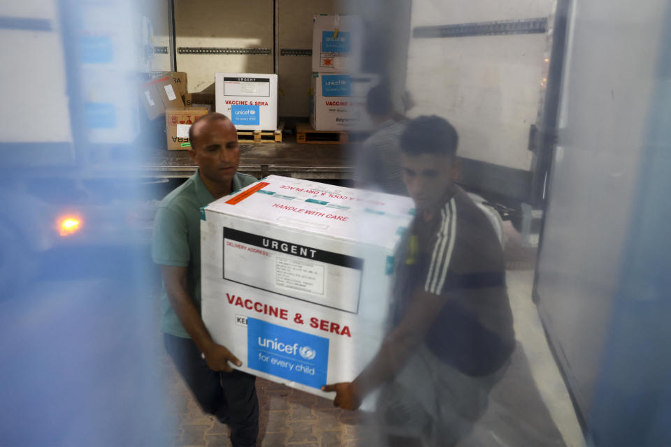 Workers unload polio vaccines provided to the Gaza Strip with support from UNICEF at the Karm Abu Salem border crossing, also known as Kerem Shalom, at a Gaza Ministry of Health depot, August 25, 2024, amid the ongoing conflict in the Palestinian territory between Israel and Hamas. / Credit: EYAD BABA/AFP/Getty