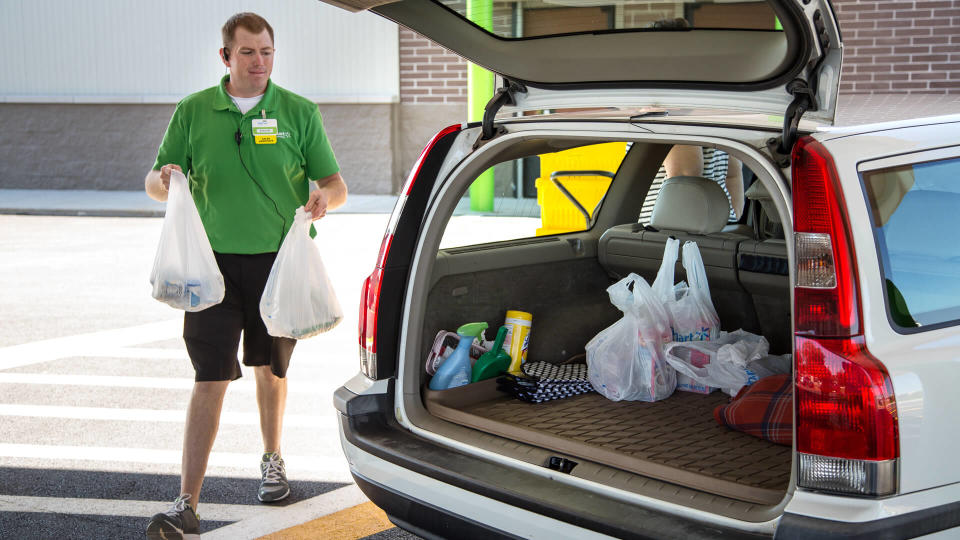 Walmart associate delivering free grocery pickup to customer