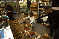 A liquor store is re-stocked Sunday May 31, 2020 in Johannesburg, as bottle stores prepare to reopen Monday after being closed for over two months under lockdown restrictions in a bid to prevent the spread of coronavirus. As the government lifts some of it's restrictions sales will be limited to certain days and hours. (AP Photo/Denis Farrell)