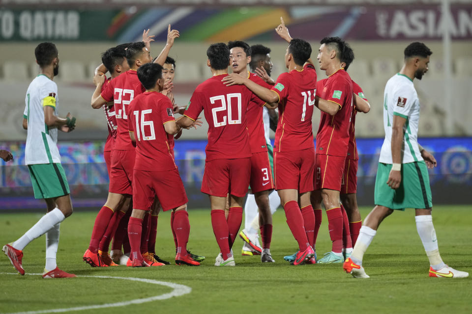 FILE - Chinese players celebrate after a goal during the World Cup 2022 qualifier between China and Saudi Arabia in Sharjah, United Arab Emirates, Thursday, March 24, 2022. China is missing out on the World Cup again despite spending millions — probably billions — to develop the game, a reported priority of Xi Jinping, the all-powerful general secretary of the Chinese Communist Party. (AP Photo/Ebrahim Noroozi, File)