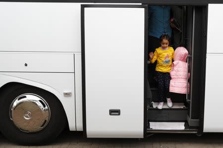 FILE PHOTO - Syrian refugees disembark from a bus on arrival at the camp for refugees and migrants in Friedland, Germany April 4, 2016. REUTERS/Kai Pfaffenbach