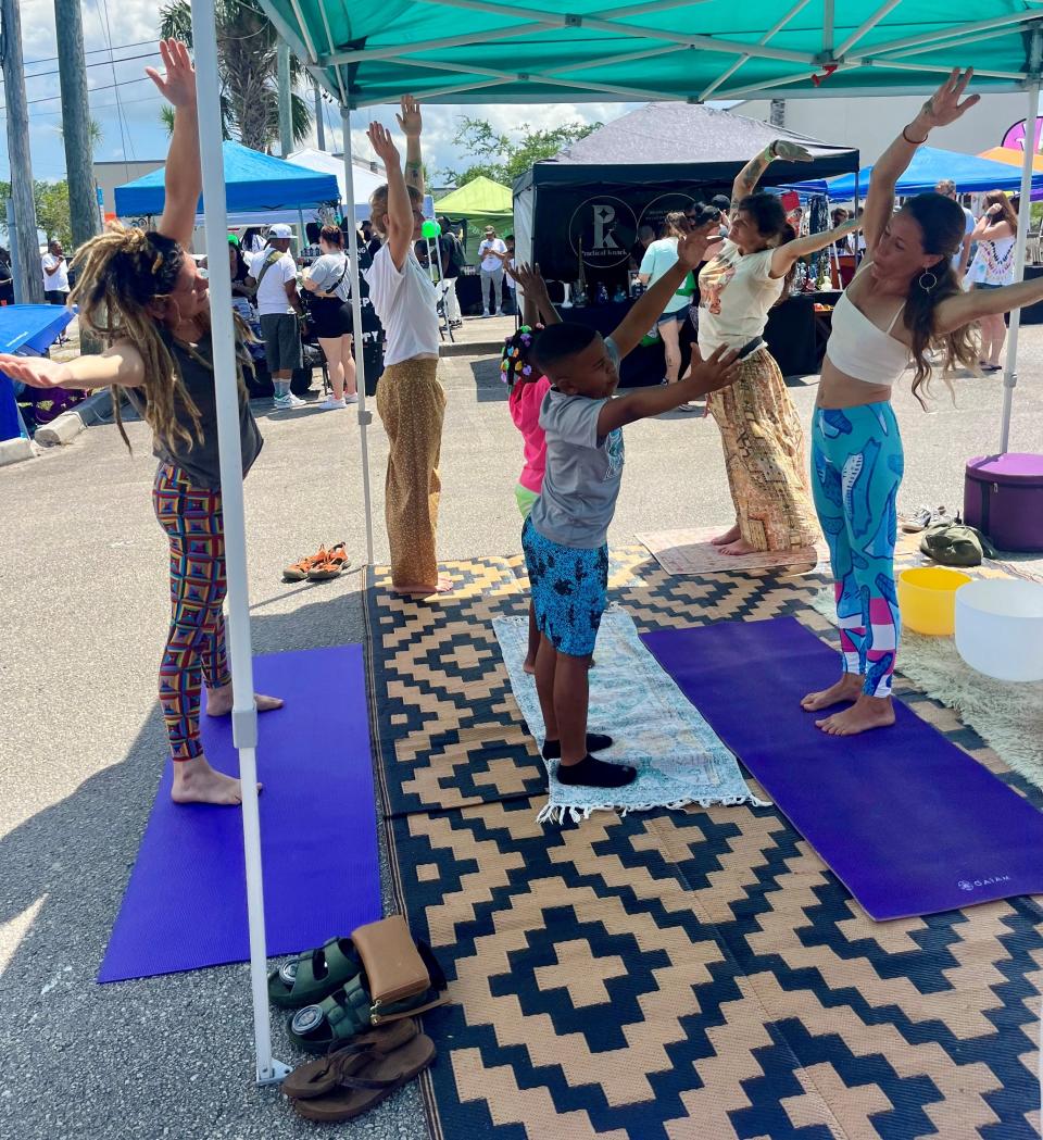 Brevard Hemp Fest attendees participate in an outdoor yoga session.