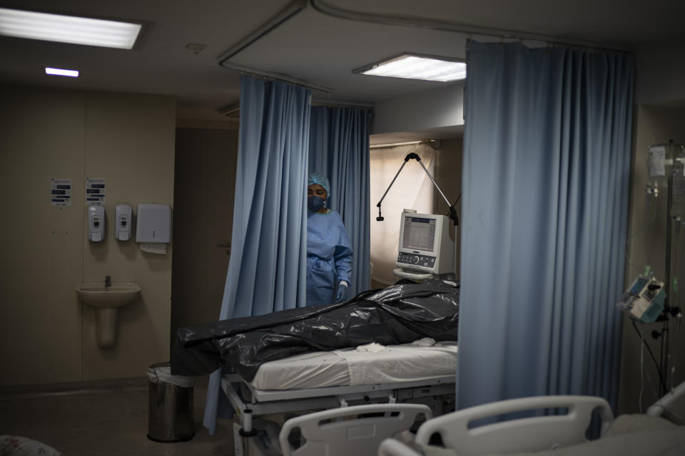 The body of a COVID-19 victim lies in a body bag at the ICU of the Sao Jose municipal hospital in Duque de Caxias, Brazil, Wednesday, March 24, 2021. (AP Photo/Felipe Dana)