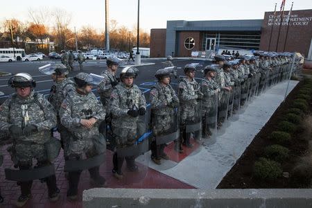 National Guard soldiers stand in formation outside the Ferguson Police Department following a night of rioting in Ferguson, Missouri November 25, 2014. REUTERS/Lucas Jackson