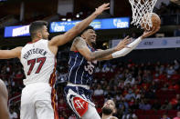 Houston Rockets center Christian Wood (35) shoots past Miami Heat center Omer Yurtseven (77) during the second half of an NBA basketball game Friday, Dec. 31, 2021, in Houston. (AP Photo/Michael Wyke)