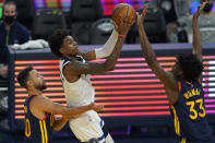 Minnesota Timberwolves forward Jaden McDaniels, middle, shoots between Golden State Warriors guard Stephen Curry, left, and center James Wiseman (33) during the first half of an NBA basketball game in San Francisco, Monday, Jan. 25, 2021. (AP Photo/Jeff Chiu)