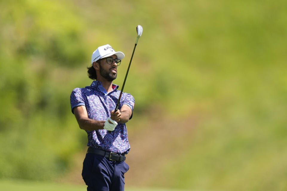 Akshay Bhatia watches his shot on the first fairway during the third round of the John Deere Classic golf tournament, Saturday, July 8, 2023, at TPC Deere Run in Silvis, Ill. (AP Photo/Charlie Neibergall)