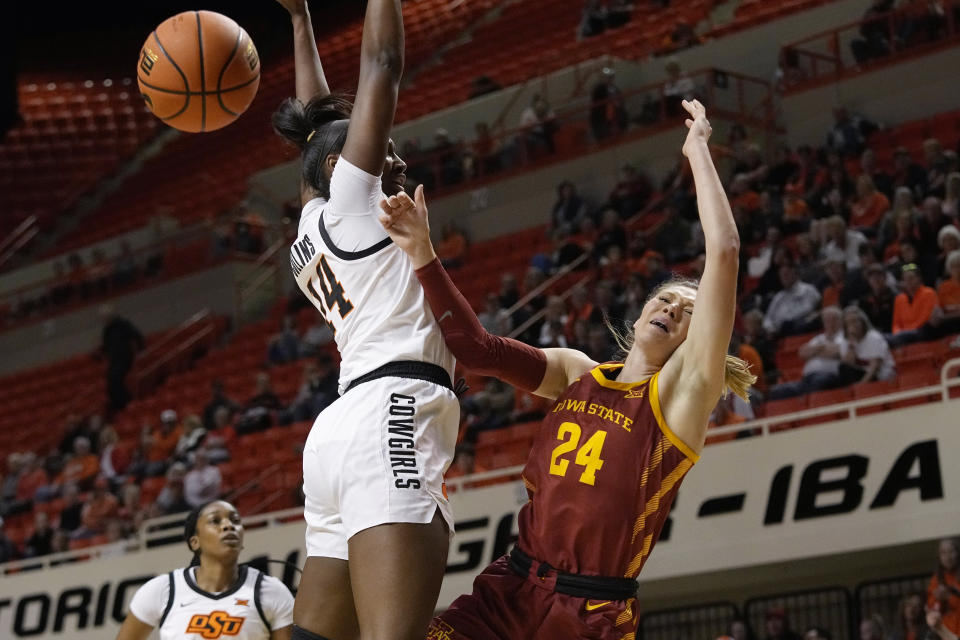 Iowa State guard Ashley Joens (24) loses control of the ball while defended by Oklahoma State forward Taylen Collins, left, in the first half of an NCAA college basketball game, Wednesday, Feb. 22, 2023, in Stillwater, Okla. (AP Photo/Sue Ogrocki)