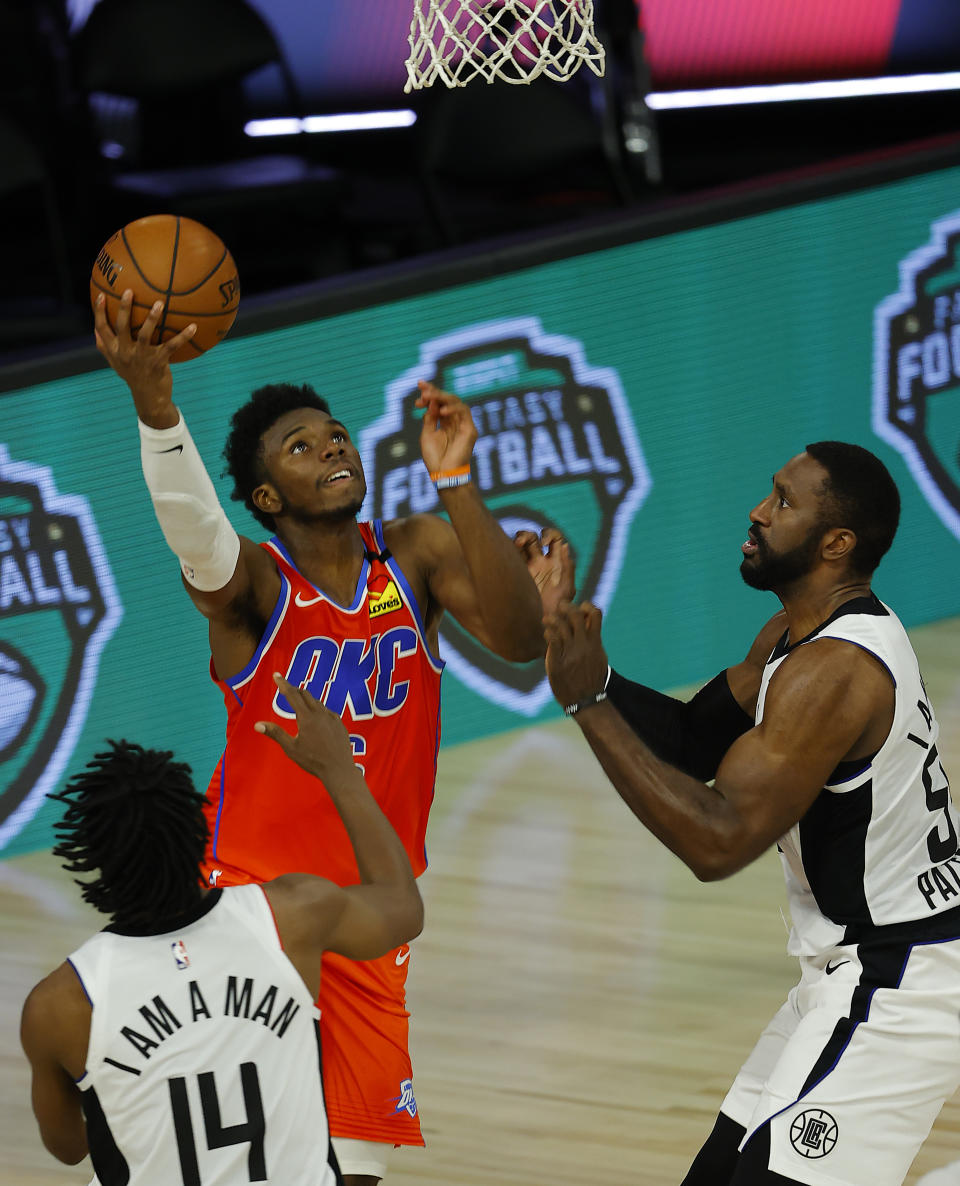 Oklahoma City Thunder's Hamidou Diallo (6) goes up for a basket as Los Angeles Clippers' Terance Mann (14) watches during the fourth quarter of an NBA basketball game Friday, Aug. 14, 2020, in Lake Buena Vista, Fla. (Mike Ehrmann/Pool Photo via AP)