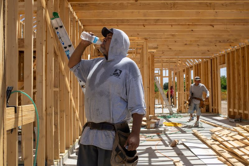 FILE PHOTO: Builder takes water break during hot weather in Manvel, Texas