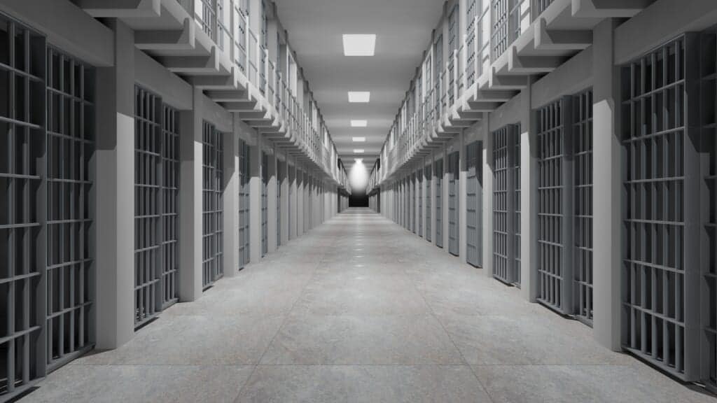 Rows of prison cells, prison interior. (Adobe Stock)