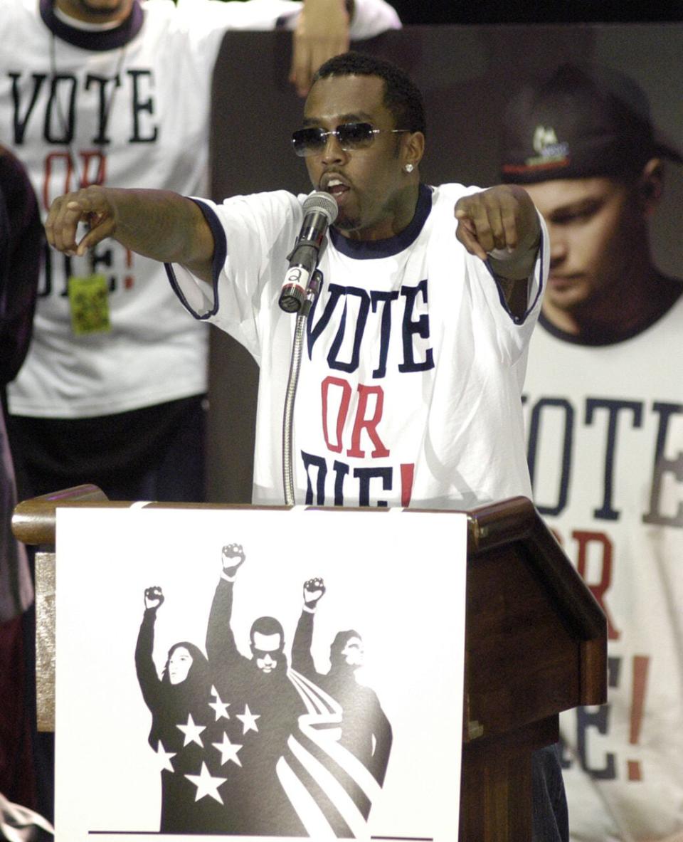 Singer Sean “P. Diddy” Combs gestures as he speaks to students at Temple University during a stop in his Vote or Die! Tour October, 27, 2004 in Philadelphia, Pennsylvania. The Vote or Die! Tour is traveling to six cities in three days to educate, motivate, and empower young Americans across the country to vote. (Photo by William Thomas Cain/Getty Images)