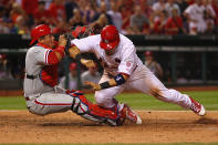 ST. LOUIS, MO - MAY 25: Carlos Ruiz #51 of the Philadelphia Phillies tags out Yadier Molina #4 of the St. Louis Cardinals at Busch Stadium on May 25, 2012 in St. Louis, Missouri. (Photo by Dilip Vishwanat/Getty Images)