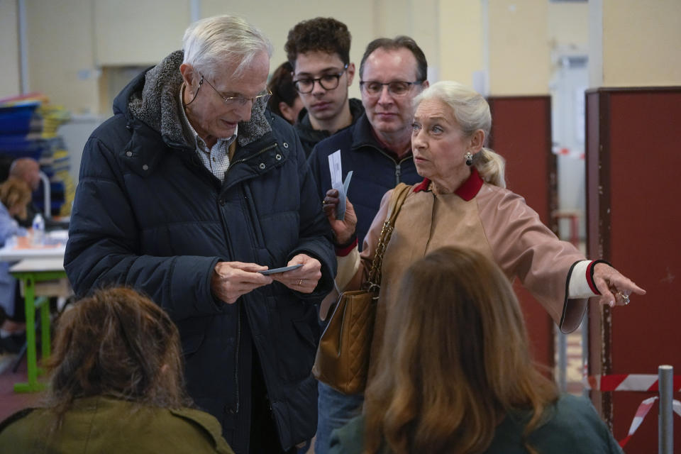 Voters queue to cast their ballots in Paris, France, Sunday, April 24, 2022. France began voting in a presidential runoff election Sunday with repercussions for Europe's future, with centrist incumbent Emmanuel Macron the front-runner but fighting a tough challenge from far-right contender Marine Le Pen. (AP Photo/Michel Euler)