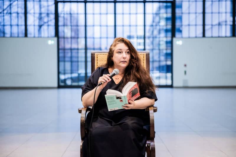 Tania Bruguera, artist and activist, reads from Hannah Arendt's "Elements and Origins of Totalitarianism" before a press event for her performance "Where Your Ideas Become Civic Actions (100 Hours Reading The Origins of Totalitarianism)" at Hamburger Bahnhof - Nationalgalerie der Gegenwart. Christoph Soeder/dpa