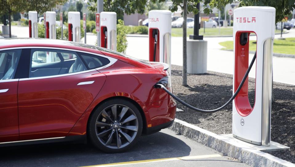 A Tesla Model S is plugged in at a vehicle Supercharging station