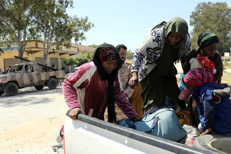 Members of Libyan internationally recognised government forces evacuate an African family during the fighting with Eastern forces, at Al-Swani area in Tripoli, Libya April 18, 2019. REUTERS/Ahmed Jadallah