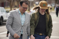 A man holds hands with a student following their reunion after a school shooting at East High School Wednesday, March 22, 2023, in Denver. Two school administrators were shot at the high school Wednesday morning after a handgun was found on a student subjected to daily searches, authorities said. (AP Photo/David Zalubowski)