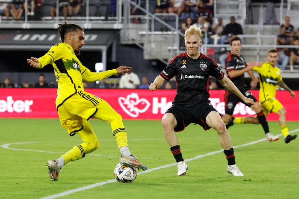 Sep 28, 2024; Washington, District of Columbia, USA; Columbus Crew defender Mohamed Farsi (23) dribbles the ball as D.C. United midfielder Matti Peltola (4) defends in the second half at Audi Field. Mandatory Credit: Geoff Burke-Imagn Images