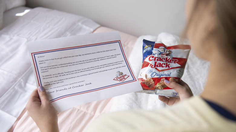 woman holding Cracker Jack package