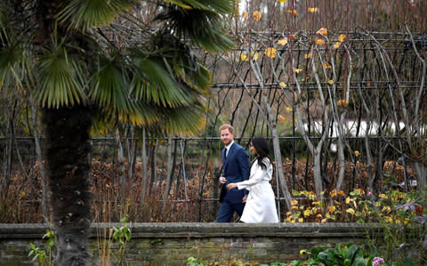 Prince Harry poses with Meghan Markle in the Sunken Garden of Kensington Palace - Credit: Reuters