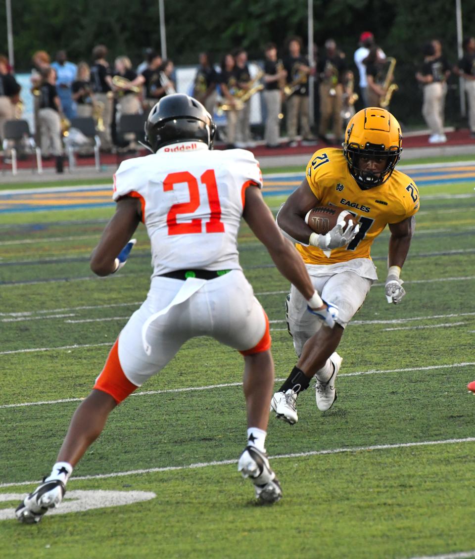 Zion James (21) eyes first-down yards for Walnut Hills at Marx Stadium, Aug. 17, 2023.