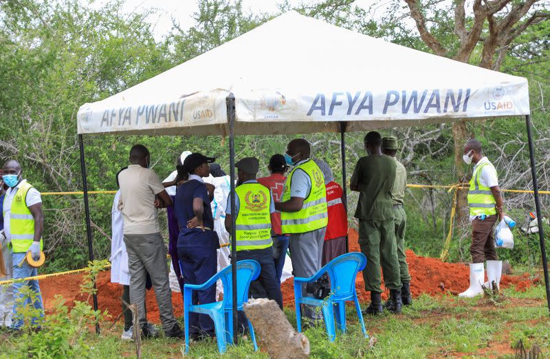 FILE PHOTO: Forensic experts and homicide detectives from the Directorate of Criminal Investigations, gather to exhume bodies of starvation cult victims, in Kilifi