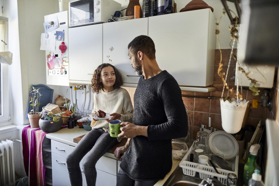 A father and daughter hanging out in the kitchen