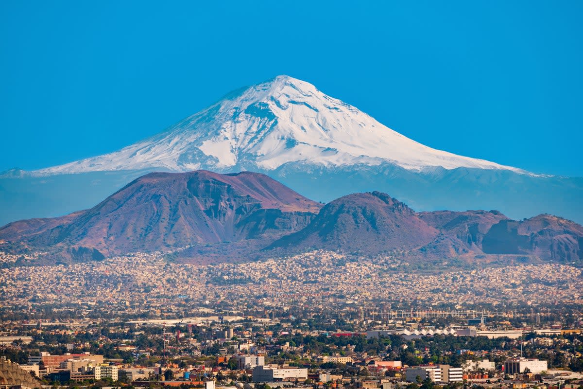 The Popocatepetl volcano provides a dramatic backdrop for the Mexican capital (Getty Images/iStockphoto)