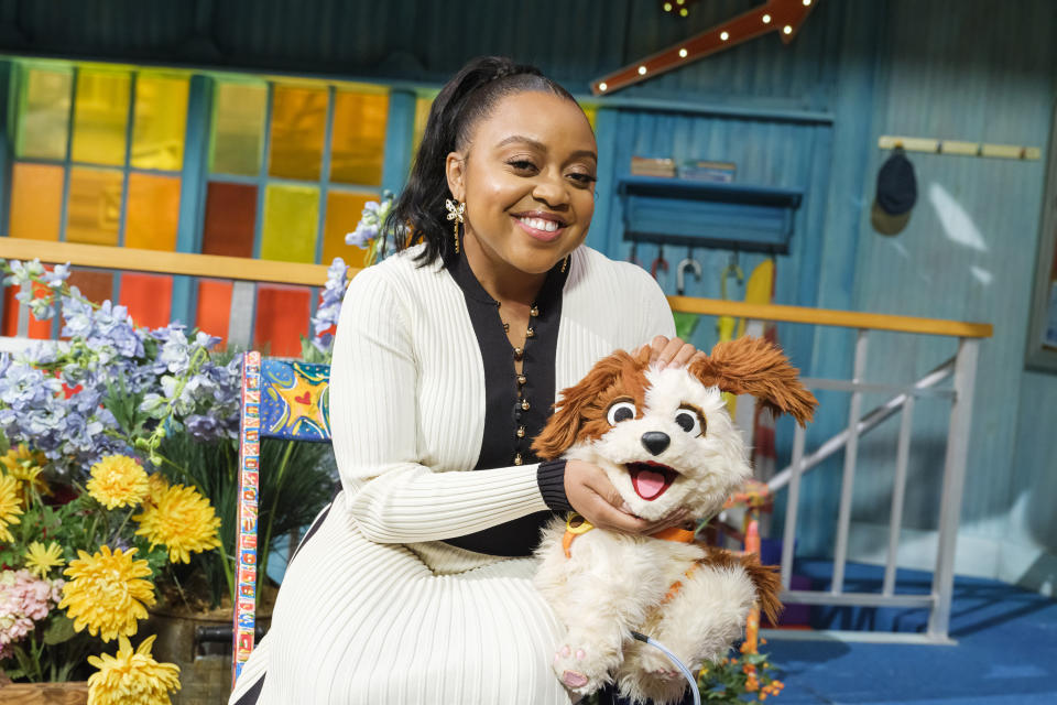 This image released by Sesame Workshop showsQuinta Brunson with muppet character Tango on the set of the children's show "Sesame Street." (Zach Hyman/Sesame Workshop via AP)