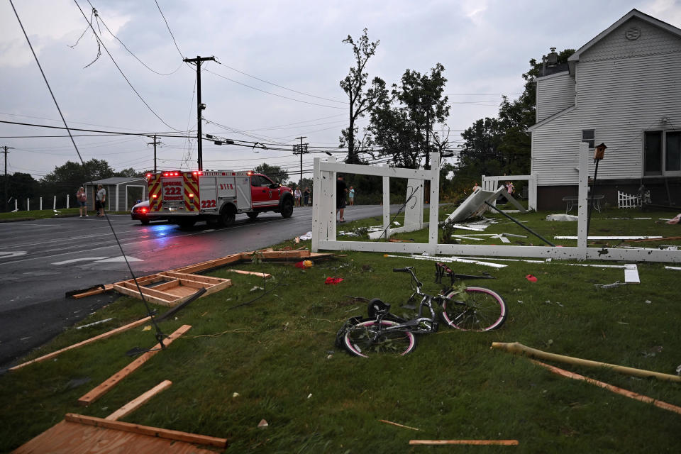 Debris is scattered in the Penn Valley Terrace trailer park after a tornado hit in Trevose, Pa. Thursday, July 29, 2021. Five people were injured Thursday when a building at a Bensalem auto dealership was destroyed by severe weather, authorities said. The National Weather Service confirmed two tornados touched down in Bucks County, sending trees falling and debris flying.(Tom Gralish/The Philadelphia Inquirer via AP)