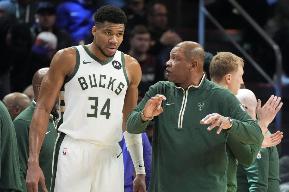 Milwaukee Bucks coach Doc Rivers, right, talks with forward Giannis Antetokounmpo (34) during the second half of the team's NBA basketball game against the Phoenix Suns on Tuesday, Feb. 6, 2024, in Phoenix. The Suns won 114-106. (AP Photo/Ross D. Franklin)