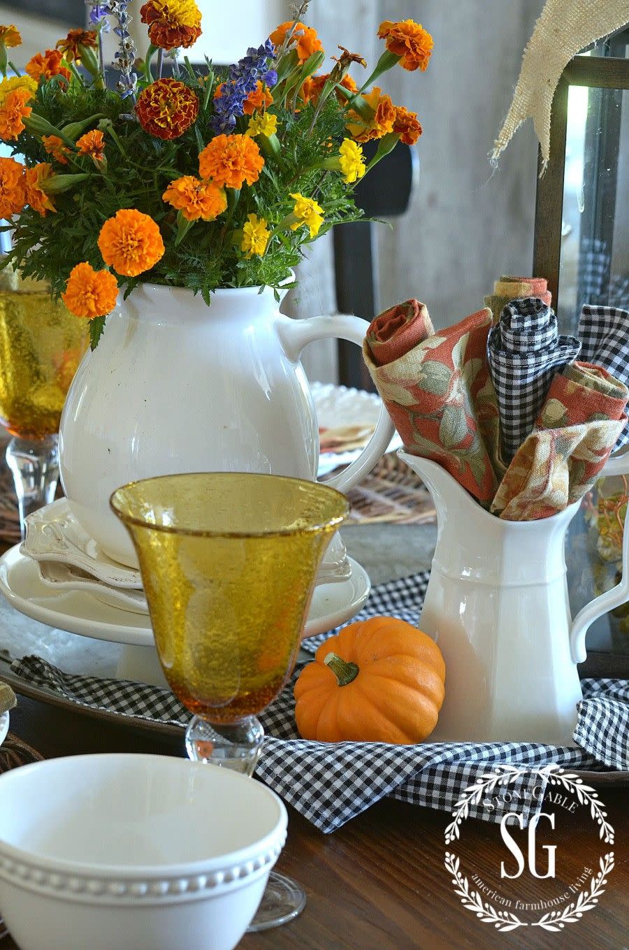 <p>Here's proof that practical is sometimes best: Roll up cloth napkins and tuck them into a pitcher for an inevitable spill. To brighten up the spread, stick cheery mums in a matching jug.</p><p><em><a href="http://www.stonegableblog.com/fall-home-tour/" rel="nofollow noopener" target="_blank" data-ylk="slk:Get the tutorial at Stone Gable »;elm:context_link;itc:0;sec:content-canvas" class="link ">Get the tutorial at Stone Gable »</a></em></p>