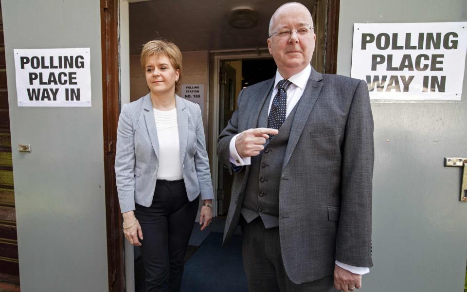 Peter Murrell and Nicola Sturgeon outside a polling station - Robert Perry/AFP/Getty Images