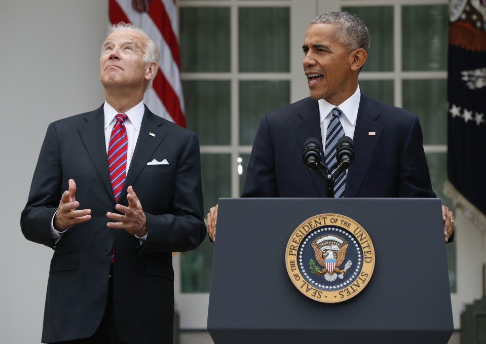 FILE - In this Nov. 9, 2016, file photo, Vice President Joe Biden, left, looks upwards while listening to President Barack Obama speak in the Rose Garden of the White House in Washington. Nearly eight years after he was last on the ballot, Obama is emerging as a central figure in the 2020 presidential election. Democrats are eagerly embracing Obama as a political wingman for Joe Biden, who spent two terms by his side as vice president. Obama remains the party’s most popular figure, particularly with black voters and younger Democrats. (AP Photo/Pablo Martinez Monsivais, File)