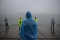 A man stands before policemen at Jindo harbour on April 17, 2014, as distraught relatives of the missing ferry passengers maintain an agonising vigil on shore