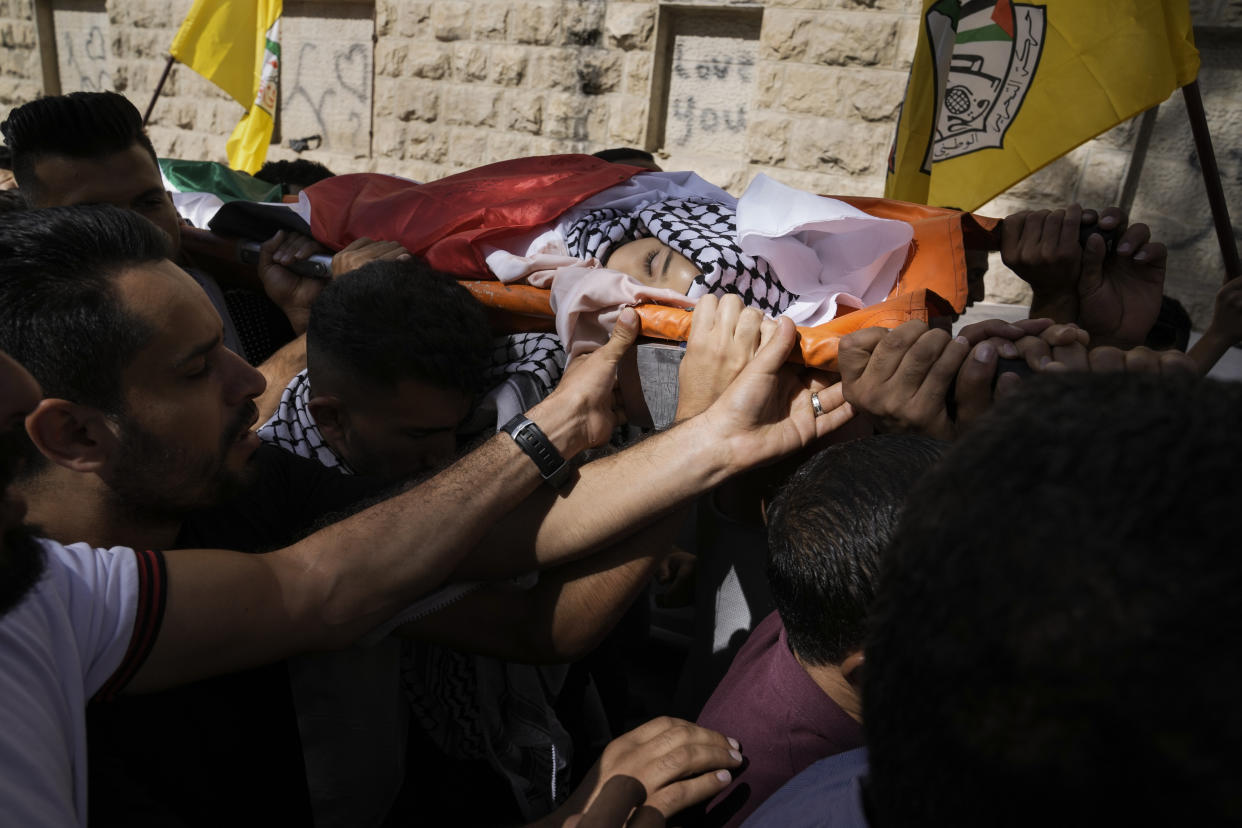 Palestinian mourners carry the body of 7-year-old Palestinian boy Rayan Suleiman, from the hospital in the West Bank village of Beit Jala to his nearby village Friday, Sept. 30, 2022. The U.S. State Department has called on Israel to open a "thorough" investigation into the mysterious death of the boy, who collapsed and died shortly after Israeli soldiers came to his home in the occupied West Bank. Relatives said he had no previous health problems and accused the army of scaring the child to death. The army called the death a tragedy and said its soldiers were not to blame. (AP Photo/Mahmoud Illean)
