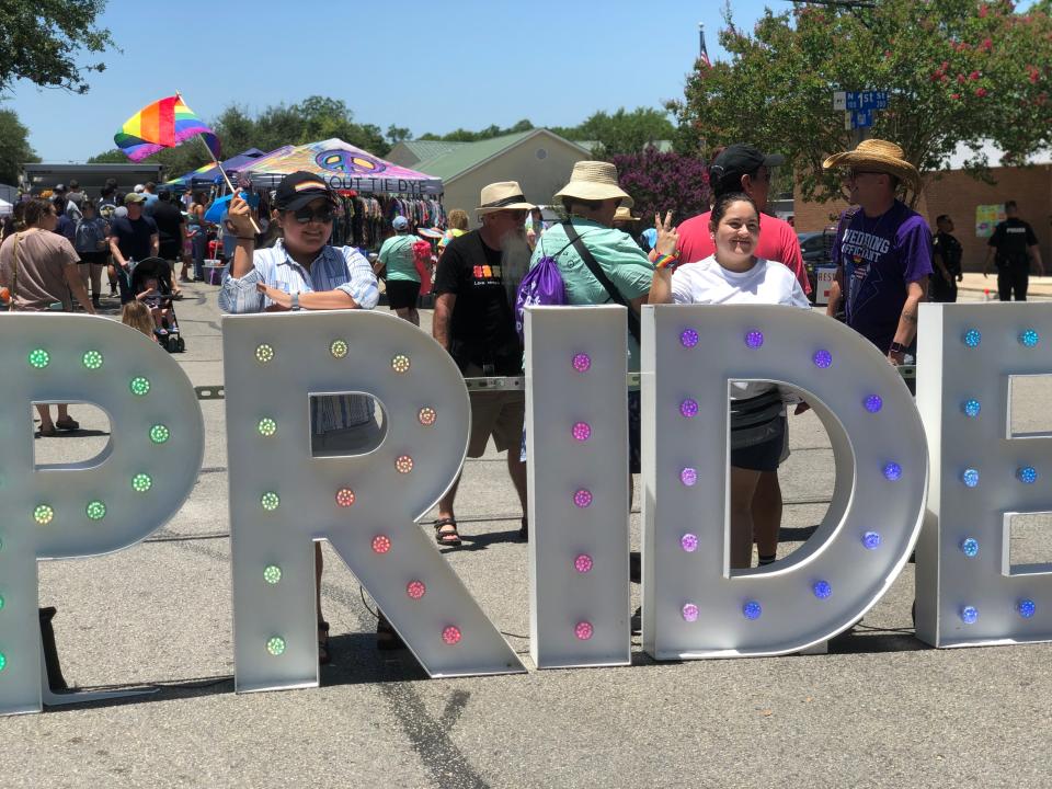 Priscilla Mendoza, left, and Bernice Mendoza post at a photo-op at the first Gay Pride event in Pflugerville on June 18. The festival was hosted by Pflugerville Pride.
