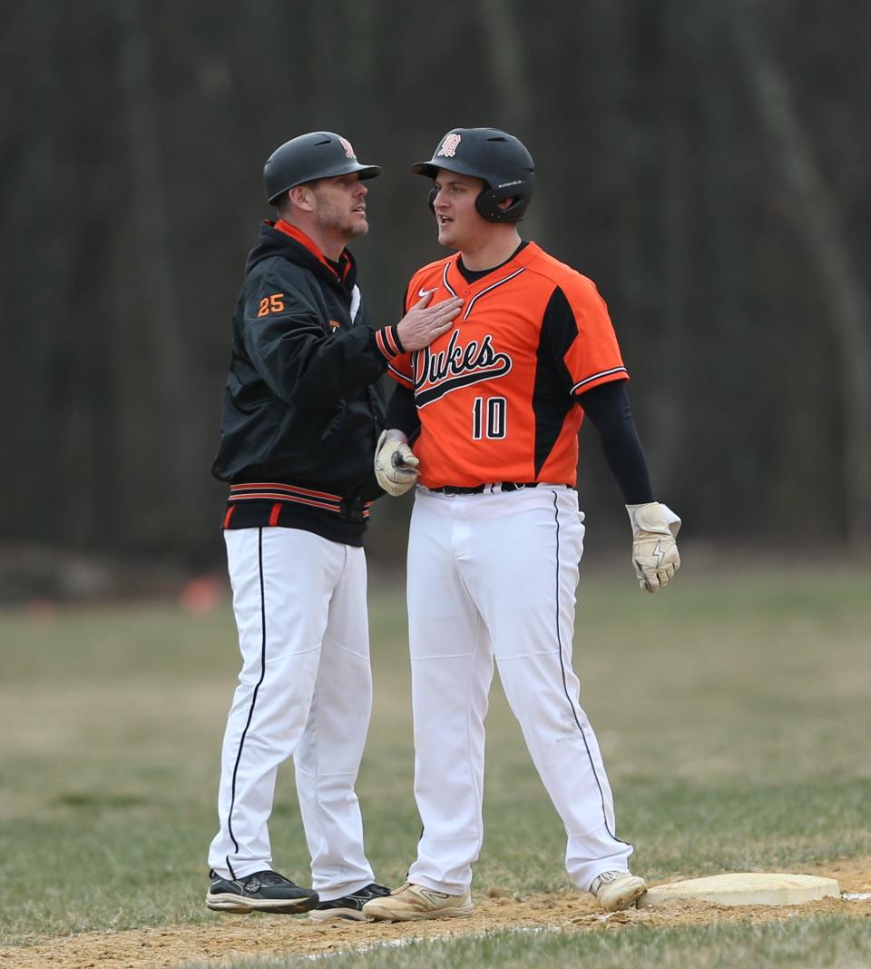 Marlboro baseball coach John Morrissey gives instructions to Tommy Benfer at third base during a March 27, 2024 game.