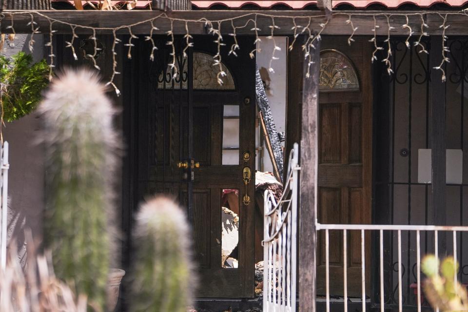 The front door of a home near the corner of 43rd Avenue and East Union Hills Drive went ablaze overnight on Thursday, July 14, 2022, in Phoenix. More than 50 firefighters responded to the first alarm fire at the home which had a propane tank and downed power lines.