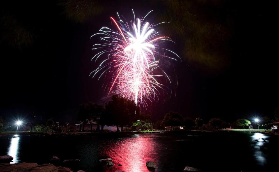 Fireworks light up the sky over the lake at Barney Schwartz Park in Paso Robles on Tuesday, July 4, 2023.