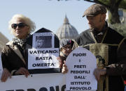 Demonstrators against pedophilia show banners reading "Vatican, stop omerta' " and "out the pedophile priests from provolo Institute" as they participate in a march promoted by members of the ECA (Ending Clergy Abuse), in downtown Rome, Saturday, Feb. 23, 2019. Verona's Provolo Institute for the Deaf denounced sexual abuse, pedophilia and corporal punishment that occurred at the school from the 1950's to the 1980's. (AP Photo/Alessandra Tarantino)