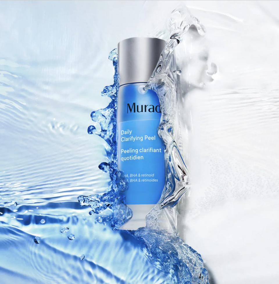 Product shot of Murad Daily Clarifying Peel bottle surrounded by splash of water