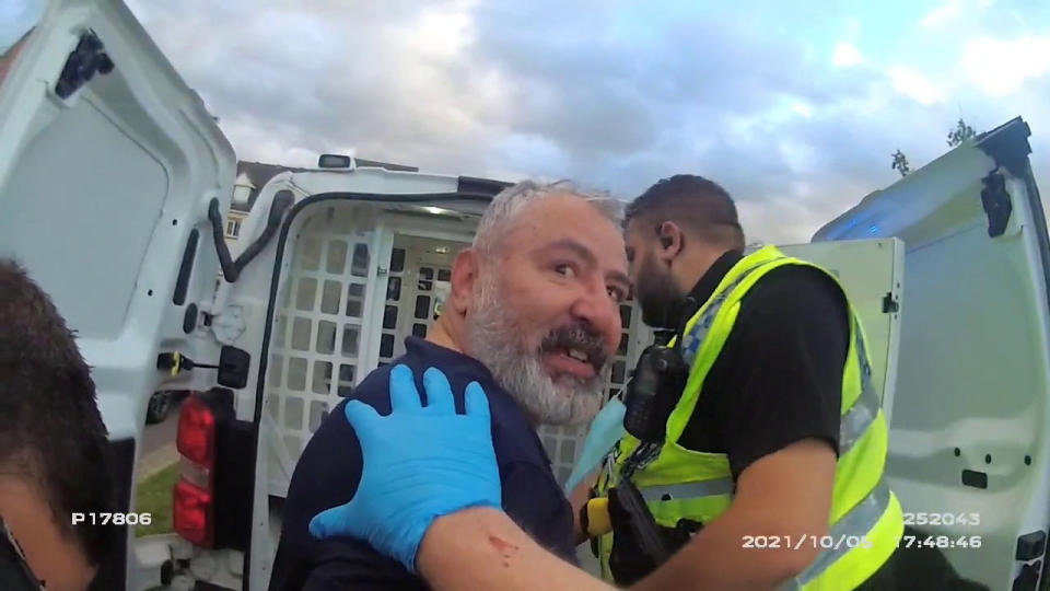 Chilling video footage shows Can Arslan, 52, laughing as he is arrested after killing neighbour Matthew Boorman. (SWNS)