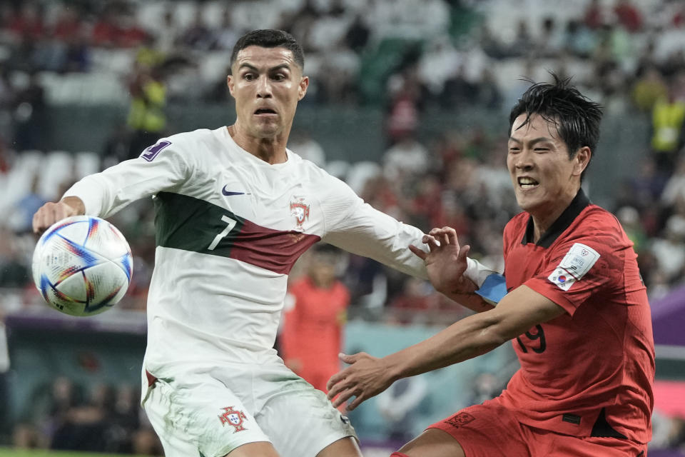 Portugal's Cristiano Ronaldo, left and South Korea's Kim Young-gwon vie for the ball during the World Cup group H soccer match between South Korea and Portugal, at the Education City Stadium in Al Rayyan , Qatar, Friday, Dec. 2, 2022. (AP Photo/Hassan Ammar)