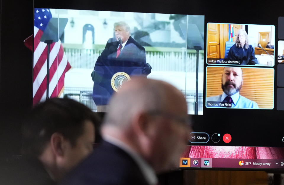 Witness Thomas Van Flein, bottom right on video screen, is shown with Judge Sarah B. Wallace, top right, and former President Donald Trump during a hearing for a lawsuit to keep former President Donald Trump off the state ballot, Thursday, Nov. 2, 2023, in Denver District Court in Denver. (AP Photo/David Zalubowski, Pool)